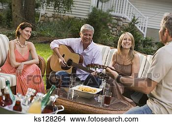 Stock Photo - men playing guitars 
with women. fotosearch 
- search stock 
photos, pictures, 
images, and photo 
clipart