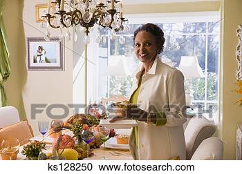 Stock Photography - woman setting 
dining room table. 
fotosearch - search 
stock photos, 
pictures, images, 
and photo clipart