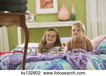 Stock Photo - girls watching 
television. fotosearch 
- search stock 
photos, pictures, 
images, and photo 
clipart