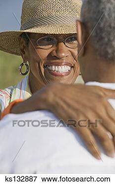 Picture - smiling woman 
embracing man. 
fotosearch - search 
stock photos, 
pictures, images, 
and photo clipart
