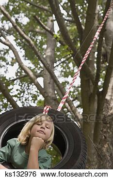 Stock Photo - boy on tire swing. 
fotosearch - search 
stock photos, 
pictures, images, 
and photo clipart