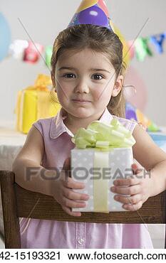 Stock Photography - birthday girl 
holding present. 
fotosearch - search 
stock photos, 
pictures, images, 
and photo clipart