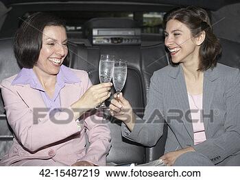 Stock Photograph - businesswomen 
celebrating in 
limousine. fotosearch 
- search stock 
photos, pictures, 
images, and photo 
clipart