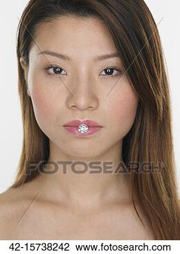Stock Photo - woman with diamond 
between lips. 
fotosearch - search 
stock photos, 
pictures, images, 
and photo clipart