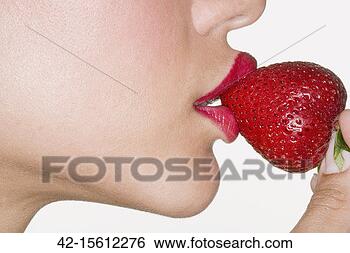 Stock Photo - young woman tasting 
strawberry. fotosearch 
- search stock 
photos, pictures, 
images, and photo 
clipart