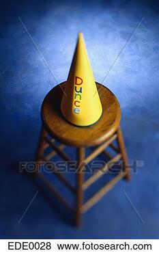 Stock Photo - dunce cap on a  stool. fotosearch  - search stock  photos, pictures,  images, and photo  clipart