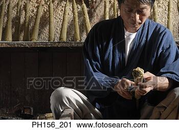 Stock Photography - close-up of a 
mid adult man 
shaping a candle. 
fotosearch - search 
stock photos, 
pictures, images, 
and photo clipart