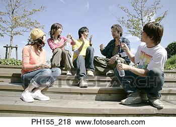 Stock Photo - two young women 
and three young 
men sitting on 
steps and smiling. 
fotosearch - search 
stock photos, 
pictures, images, 
and photo clipart