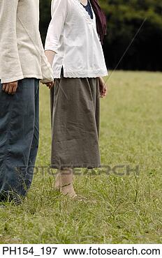 Picture - low section view 
of a man holding 
a woman's hand. 
fotosearch - search 
stock photos, 
pictures, images, 
and photo clipart