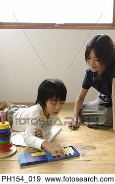 Stock Photograph - mid adult woman 
and her daughter 
coloring in a 
coloring book. 
fotosearch - search 
stock photos, 
pictures, images, 
and photo clipart