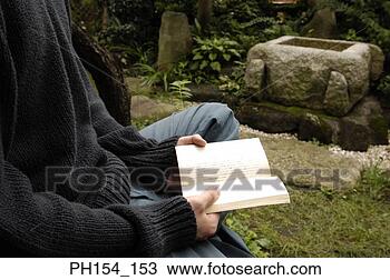 Stock Photo - mid section view 
of a man holding 
a book. fotosearch 
- search stock 
photos, pictures, 
images, and photo 
clipart