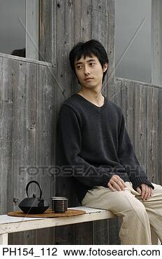 Stock Photo - side profile of 
a young man sitting 
on a bench. fotosearch 
- search stock 
photos, pictures, 
images, and photo 
clipart