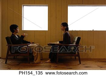 Stock Image - side profile of 
a young couple 
sitting near windows. 
fotosearch - search 
stock photos, 
pictures, images, 
and photo clipart