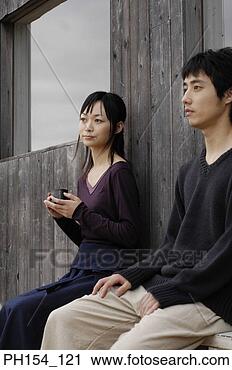 Stock Photography - young couple sitting 
on a bench. fotosearch 
- search stock 
photos, pictures, 
images, and photo 
clipart