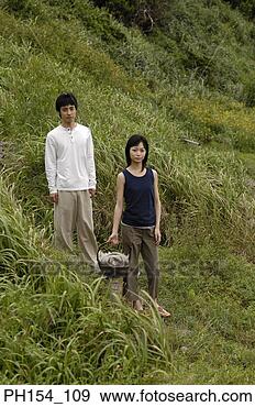 Stock Photograph - young couple standing 
on a path. fotosearch 
- search stock 
photos, pictures, 
images, and photo 
clipart