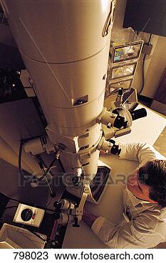 Stock Photo - scientist operating 
electron microscope. 
fotosearch - search 
stock photos, 
pictures, images, 
and photo clipart