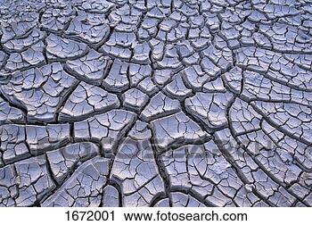 Stock Photography - close up of cracked 
mud in an arid 
landscape. fotosearch 
- search stock 
photos, pictures, 
images, and photo 
clipart