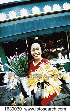 Stock Photography - florist carrying 
buckets of flowers 
on pavement outside 
a shop. fotosearch 
- search stock 
photos, pictures, 
images, and photo 
clipart