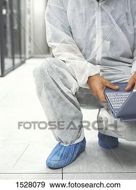 Stock Photograph - low-section of 
a man in a protective 
suit crouching 
down and using 
a. fotosearch 
- search stock 
photos, pictures, 
images, and photo 
clipart