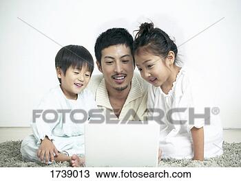 Stock Photo - father using a 
laptop computer 
with his son and 
daughter. fotosearch 
- search stock 
photos, pictures, 
images, and photo 
clipart