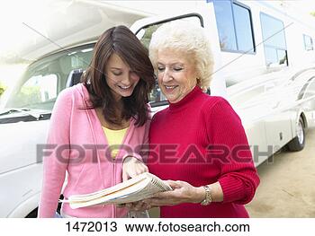 Stock Photo - grandmother and 
granddaughter 
stand in front 
of a motorhome 
looking. fotosearch 
- search stock 
photos, pictures, 
images, and photo 
clipart