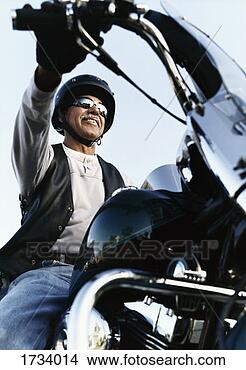 Stock Photo - low angle shot 
of a senior man 
wearing sunglasses, 
 sitting on a. 
fotosearch - search 
stock photos, 
pictures, images, 
and photo clipart