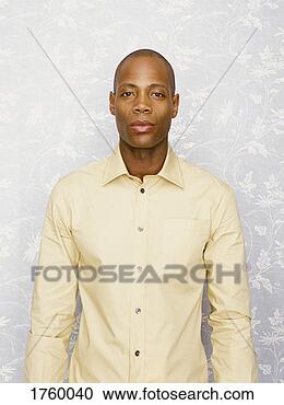 Stock Photography - portrait of a 
man wearing a 
beige shirt. fotosearch 
- search stock 
photos, pictures, 
images, and photo 
clipart