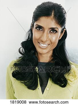 Stock Photo - portrait of a 
smiling young 
woman wearing 
a green cardigan. 
fotosearch - search 
stock photos, 
pictures, images, 
and photo clipart