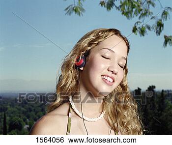 Stock Photo - teenage girl with 
her eyes closed 
listening to music. 
fotosearch - search 
stock photos, 
pictures, images, 
and photo clipart