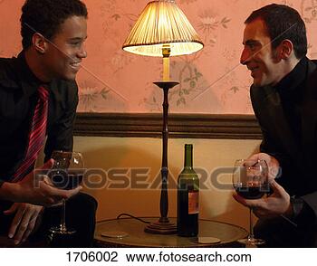 Stock Photo - two well-dressed 
men sit face to 
face at a table 
with a lamp holding. 
fotosearch - search 
stock photos, 
pictures, images, 
and photo clipart
