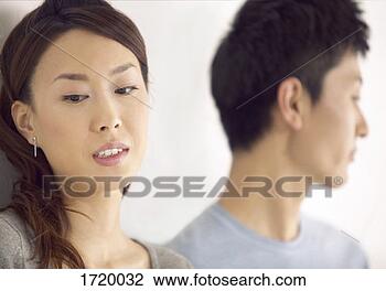 Stock Photo - close-up of a 
couple sadly looking 
away from each 
other,  focus 
on. fotosearch 
- search stock 
photos, pictures, 
images, and photo 
clipart