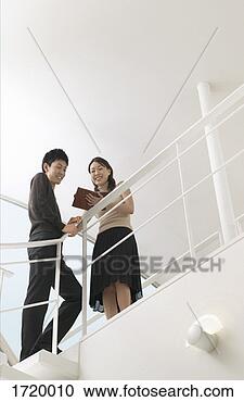 Stock Photography - smartly-dressed 
man and woman 
stand at the top 
of a stairway. 
fotosearch - search 
stock photos, 
pictures, images, 
and photo clipart