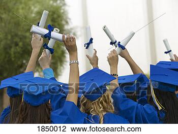 Stock Photo - group of graduates 
dressed in graduation 
gowns holding 
scrolls in the. 
fotosearch - search 
stock photos, 
pictures, images, 
and photo clipart