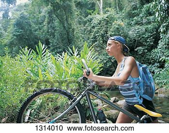 Stock Photography - woman pushing 
a mountain bike 
across a stream. 
fotosearch - search 
stock photos, 
pictures, images, 
and photo clipart