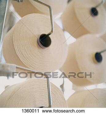 Stock Photography - close up of reels 
of white thread 
hanging from a 
loom. fotosearch 
- search stock 
photos, pictures, 
images, and photo 
clipart