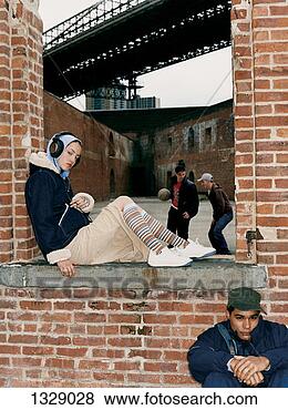 Stock Photo - four teenagers 
in a derelict 
building under 
a bridge. fotosearch 
- search stock 
photos, pictures, 
images, and photo 
clipart