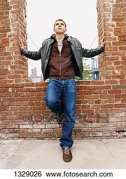 Stock Photo - teenage boy standing 
in a derelict 
building with 
his arms balanced. 
fotosearch - search 
stock photos, 
pictures, images, 
and photo clipart