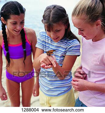 Stock Photo - three young girls 
looking at a butterfly 
on a beach. fotosearch 
- search stock 
photos, pictures, 
images, and photo 
clipart