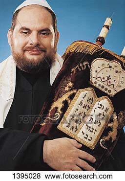 Stock Photo - rabbi stands holding 
an embroidered 
scroll of the 
torah. fotosearch 
- search stock 
photos, pictures, 
images, and photo 
clipart