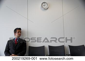Stock Photography - businessman seated 
indoors, looking 
to one side. fotosearch 
- search stock 
photos, pictures, 
images, and photo 
clipart
