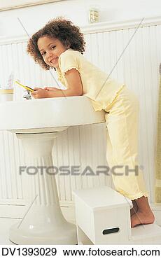 Stock Photograph - portrait of a 
girl standing 
on a step stool 
at a sink holding 
a. fotosearch 
- search stock 
photos, pictures, 
images, and photo 
clipart
