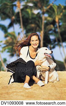 Stock Photo - portrait of a 
young woman sitting 
cross legged on 
the beach with 
her. fotosearch 
- search stock 
photos, pictures, 
images, and photo 
clipart