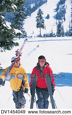 Stock Photograph - young couple walking 
up a ski slope 
carrying skis 
and ski poles. 
fotosearch - search 
stock photos, 
pictures, images, 
and photo clipart