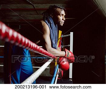 Stock Photography - young male boxer 
arms crossed resting 
on ring side, 
looking ahead. 
fotosearch - search 
stock photos, 
pictures, images, 
and photo clipart