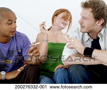 Stock Photography - young woman sitting 
between two young 
men smoking cigarettes. 
fotosearch - search 
stock photos, 
pictures, images, 
and photo clipart