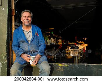 Stock Photography - senior male boat 
builder in workshop 
holding mug, smiling, 
portriat. fotosearch 
- search stock 
photos, pictures, 
images, and photo 
clipart