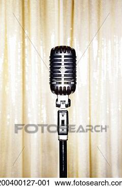 Stock Photography - retro microphone 
on stand against 
curtains, close-up. 
fotosearch - search 
stock photos, 
pictures, images, 
and photo clipart