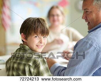 Stock Photo - boy (9-11) with 
father and female 
teacher, boy looking 
over shoulder. 
fotosearch - search 
stock photos, 
pictures, images, 
and photo clipart
