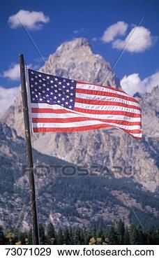 Stock Photograph - 'american flag 
with mountains, 
grand teton national 
park, wyoming'. 
fotosearch - search 
stock photos, 
pictures, images, 
and photo clipart