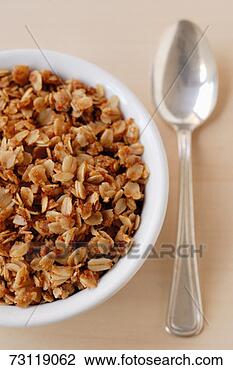Stock Photo - bowl of granola 
beside spoon, 
overhead view, 
studio. fotosearch 
- search stock 
photos, pictures, 
images, and photo 
clipart